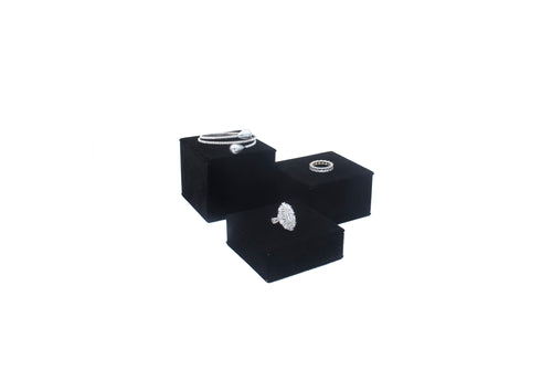 3 black risers holding jewelry 